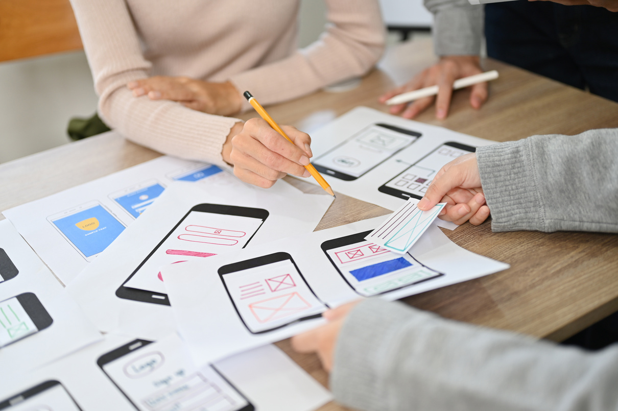A team of mobile app developers discussing on their new mobile a